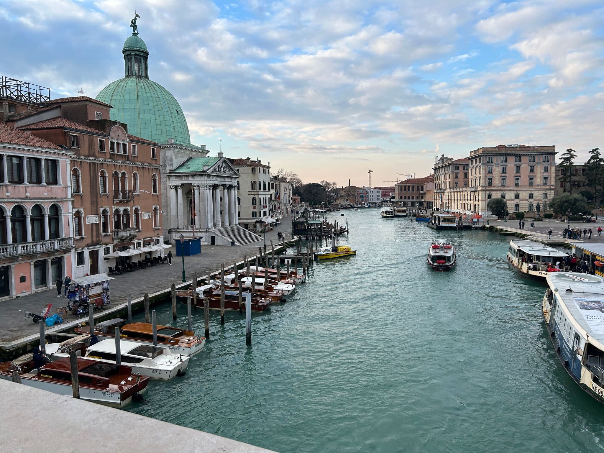San Simeone Piccolo and the Grand Canal in Venice, Italy, with docked boats and a vaporetto crossing the water
