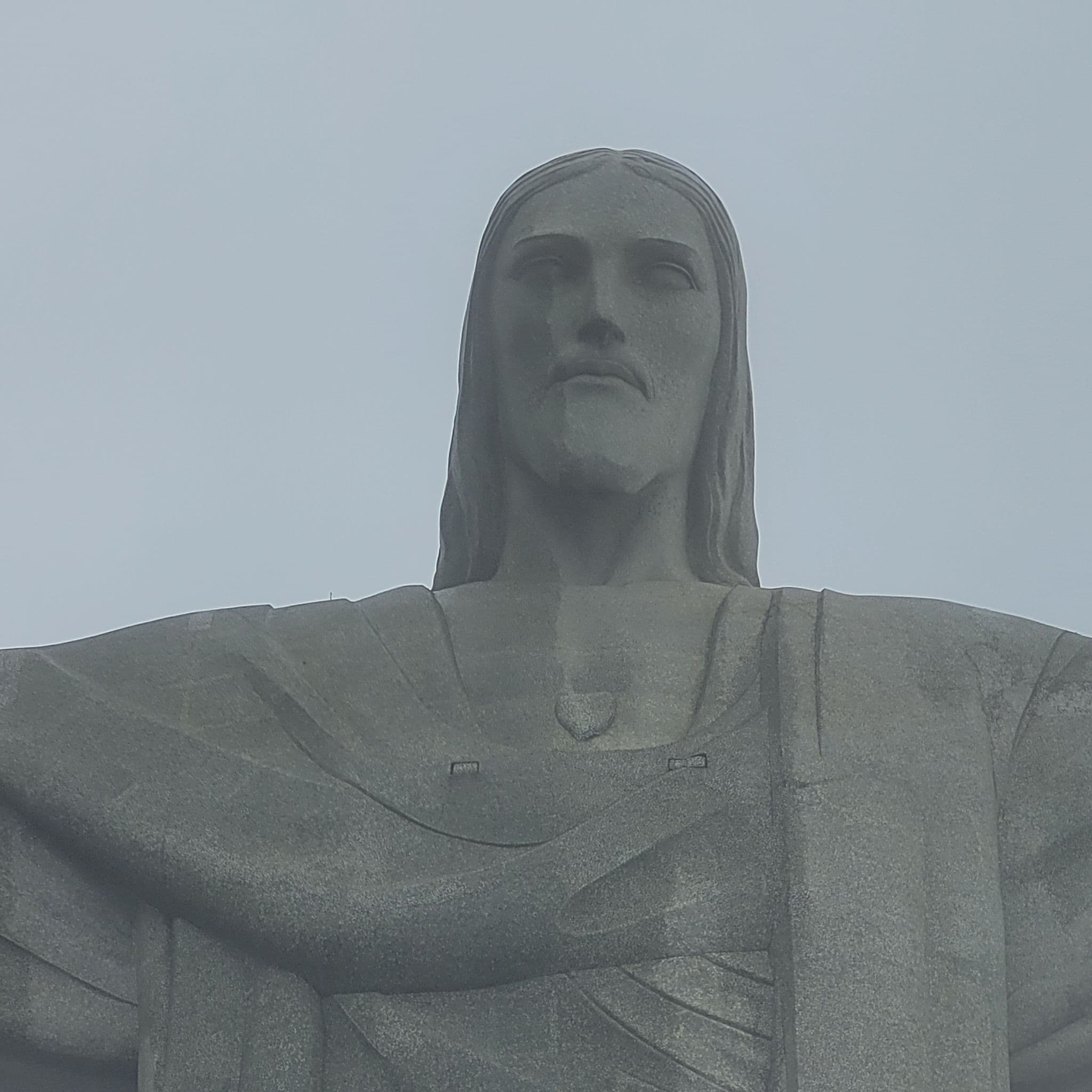Christ the Redeemer statue close-up showing the face and upper torso, overlooking Rio de Janeiro, Brazil.