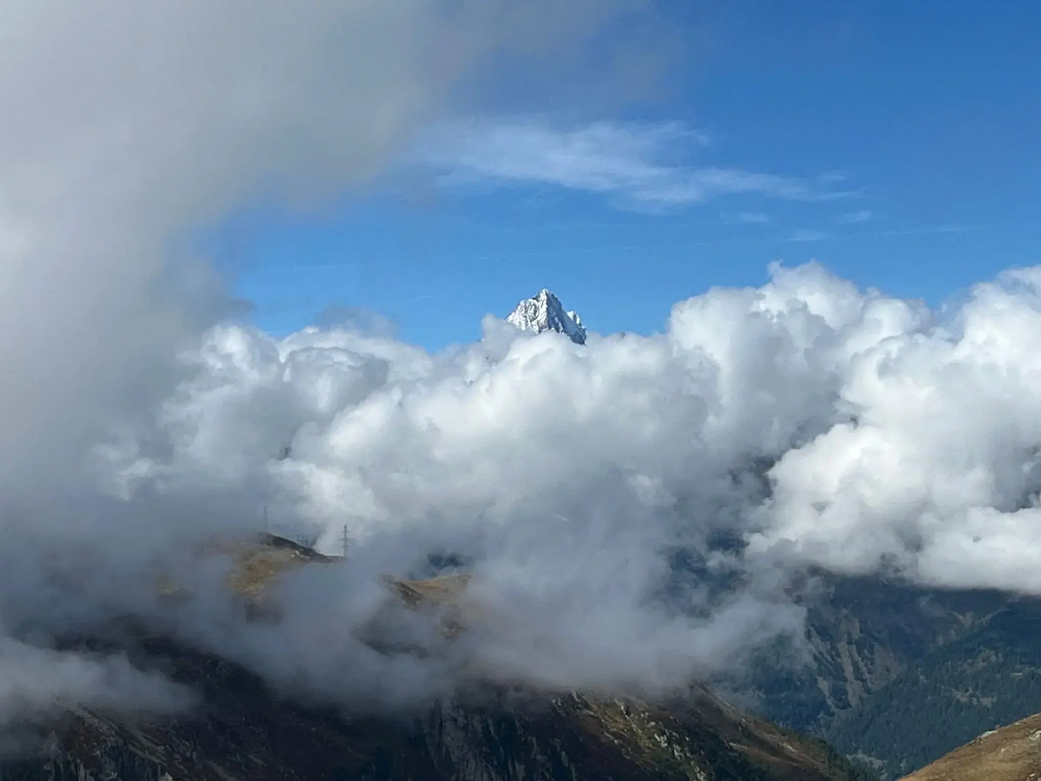 Matterhorn peak rising above thick clouds near Zermatt, Switzerland.