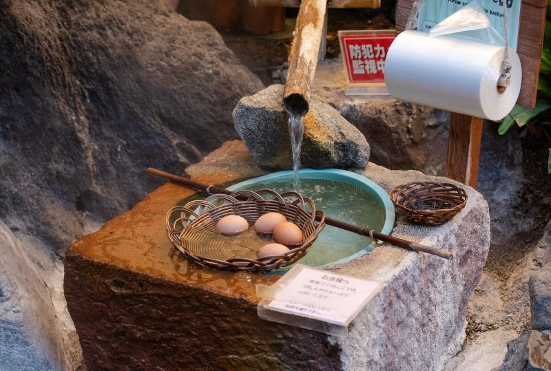 Onsen eggs simmering in baskets at a Japanese hot spring