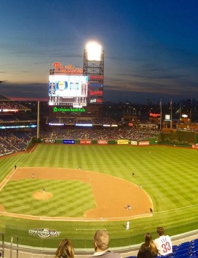 Baseball stadium with spectators during evening game under stadium lights