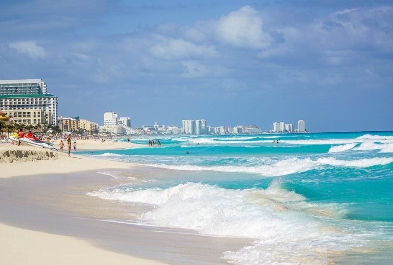Pristine white sand beach meets crystal-clear turquoise waters along Cancún's famous hotel zone