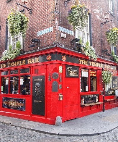 Traditional Irish pub exterior decorated for St. Patrick's Day with green shamrocks