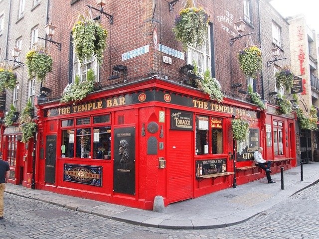 Traditional Irish pub exterior decorated for St. Patrick's Day with green shamrocks