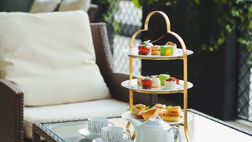 Luxury afternoon tea setup with tiered cake stand and delicate pastries