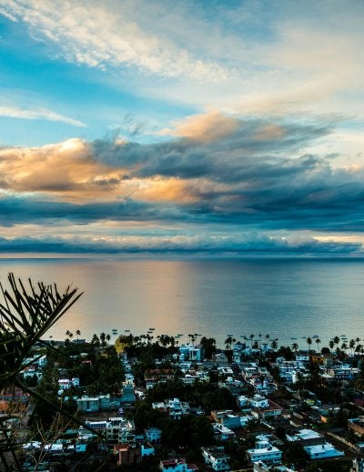 Dramatic coastal sunset painting the sky in orange and blue hues above Puerto Vallarta's picturesque bay