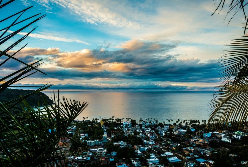 Dramatic coastal sunset painting the sky in orange and blue hues above Puerto Vallarta's picturesque bay