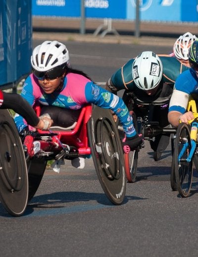 Paralympic athletes competing in wheelchair racing on a track