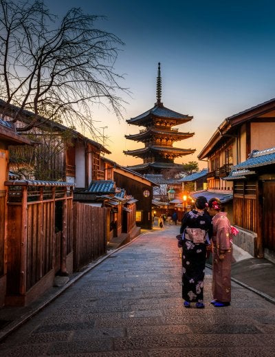 People enjoying hanami picnic under cherry blossoms in Fukuoka