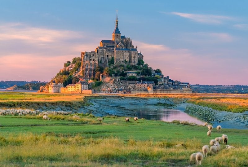 Mont Saint-Michel at sunset twilight in Normandy, northern France