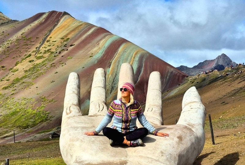 woman in vinicunca rainbow mountain