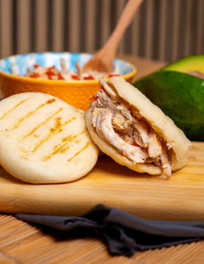 Tasty arepas stuffed with savory shredded chicken, perfect for a hearty meal.