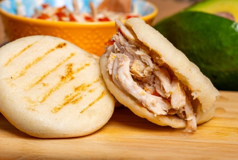 Tasty arepas stuffed with savory shredded chicken, perfect for a hearty meal.