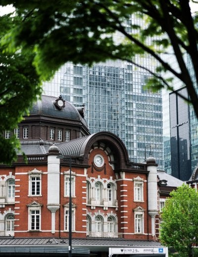 The red-brick facade of Tokyo Station's Marunouchi Building with its copper-domed towers, one of Japan's finest surviving examples of Meiji-era railway architecture in the heart of Tokyo's business district