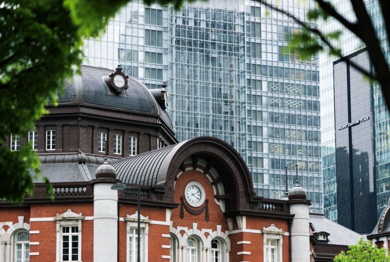The red-brick facade of Tokyo Station's Marunouchi Building with its copper-domed towers, one of Japan's finest surviving examples of Meiji-era railway architecture in the heart of Tokyo's business district