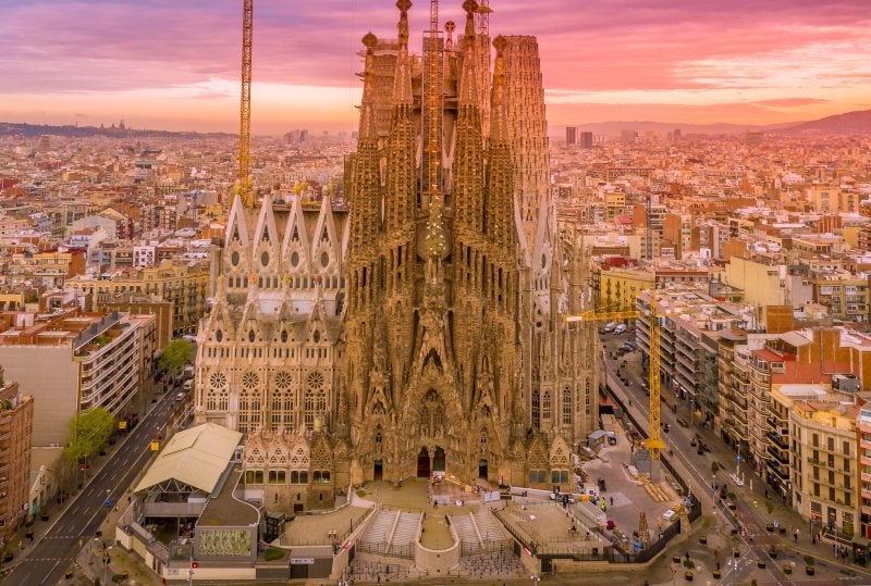 Aerial view of the Sagrada Família and Barcelona skyline at sunset