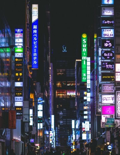 Ginza's Chuo-dori boulevard in Tokyo lined with luxury flagship stores and zelkova trees